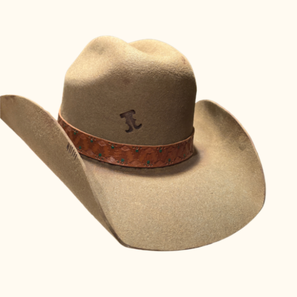 Beige cowboy hat with a brown leather band on a white background